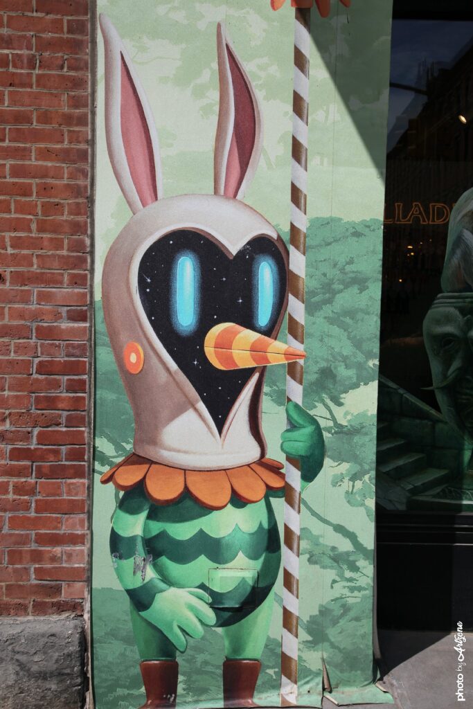 Street art de Soul Rider montrant un personnage imaginaire avec masque cosmique et oreilles de lapin peint sur un mur.