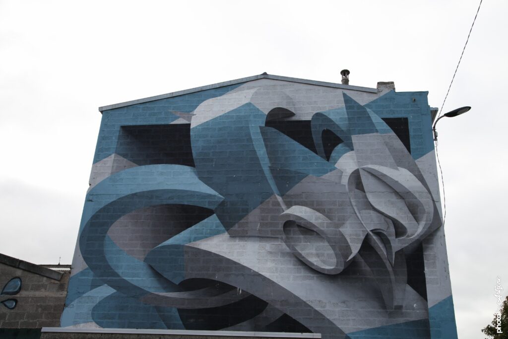 Street art abstrait de Peeta avec formes géométriques en volume peintes sur un mur à Boulogne-sur-Mer.