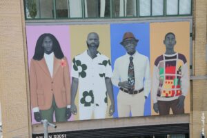 Fresque street art Amy Sherald montrant quatre portraits contemporains sur façade